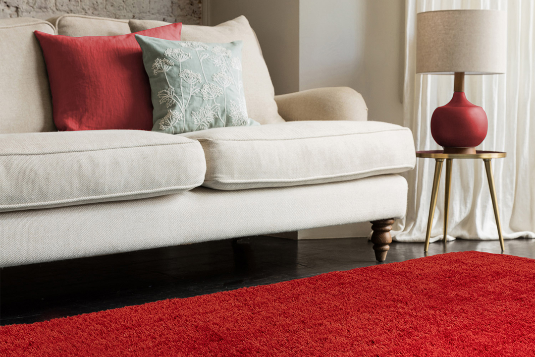 cream sofa with red rug